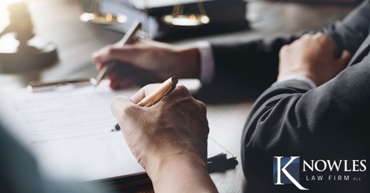 individuals going over paperwork on a table
