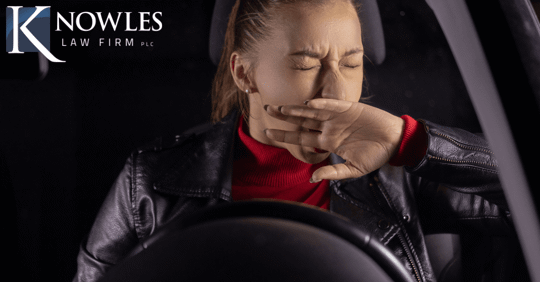 woman yawning while driving at night